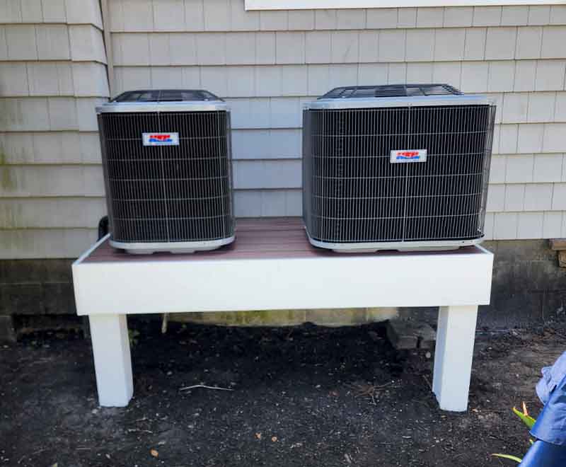 Dual outdoor HVAC condenser units installed on raised platform by L.F. Fenimore Plumbing and HVAC in South Jersey.