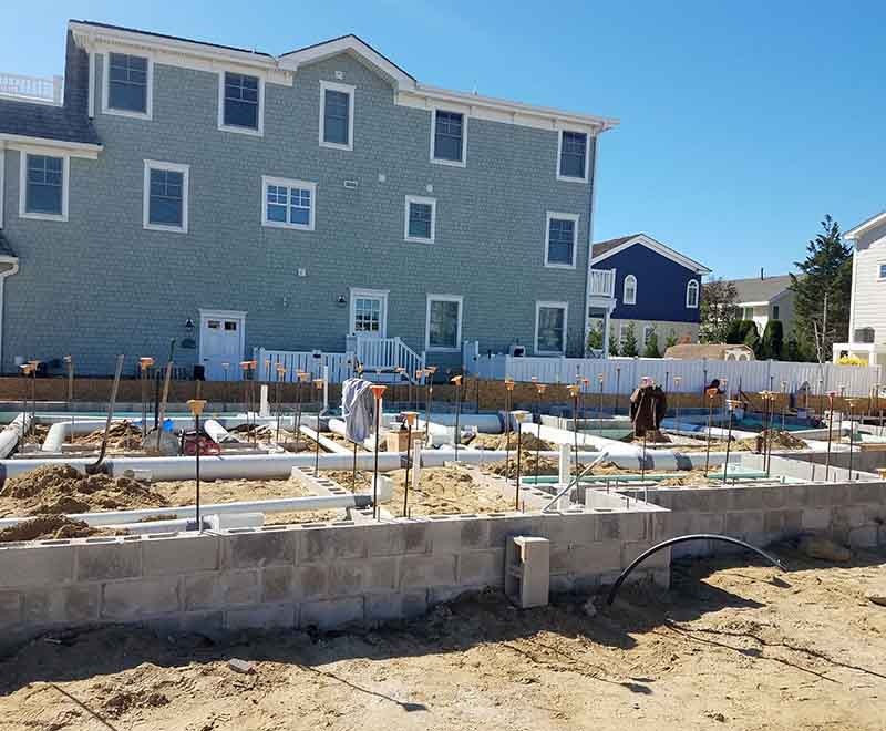 New construction plumbing rough-in installation at a residential foundation in Strathmere NJ by professional South Jersey plumbers.