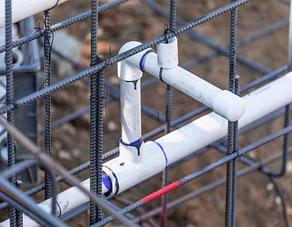 New construction plumbing rough-in with PVC piping and rebar framework by L.F. Fenimore Plumbing and HVAC in South New Jersey.